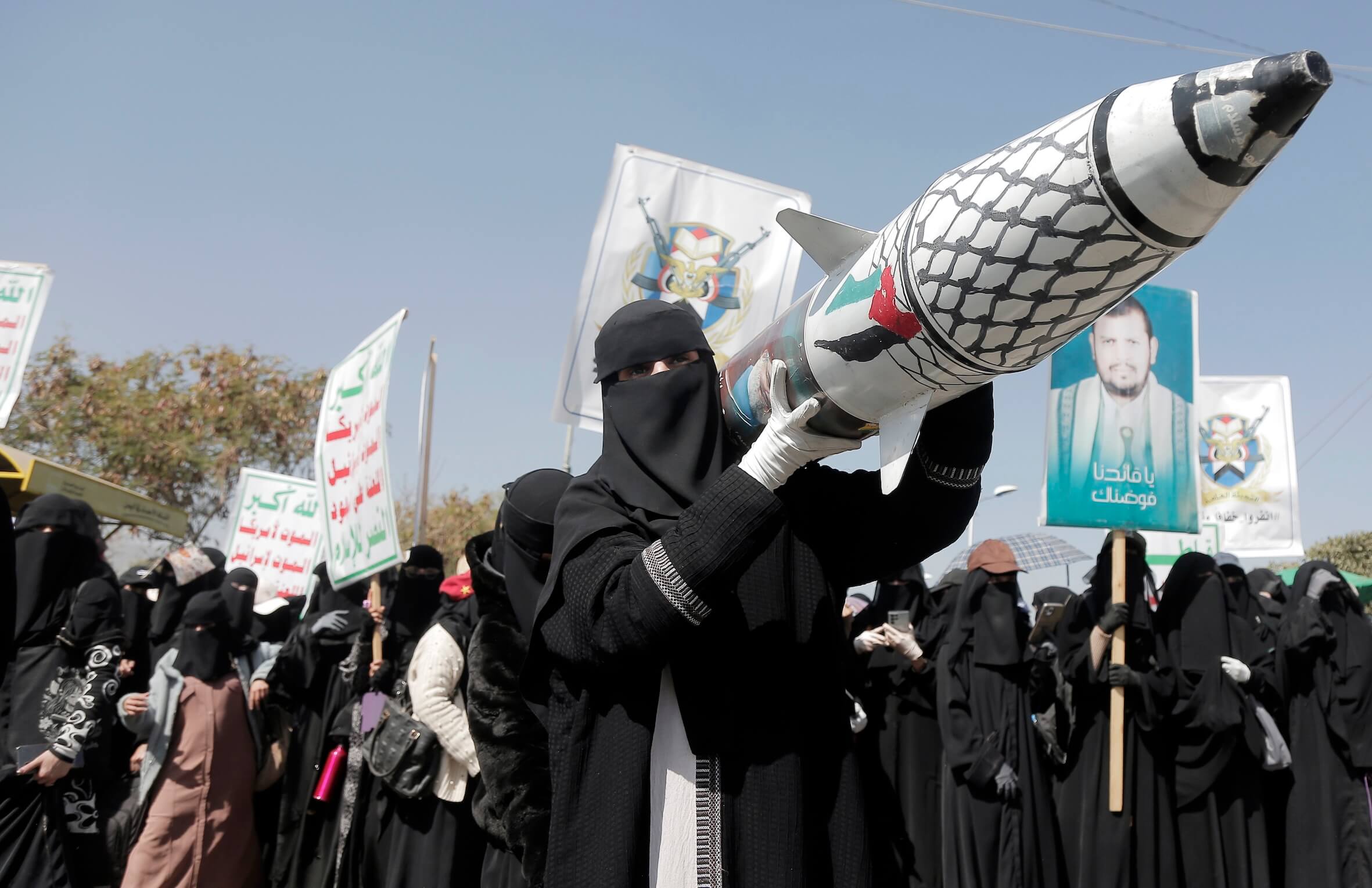 Studentinnen in Jemens Hauptstadt Sanaa tragen bei einer Demo für Gaza eine Raketen-Attrappe mit Palästina-Flagge und dem Bild von Hisbollah-Chef Nasrallah.