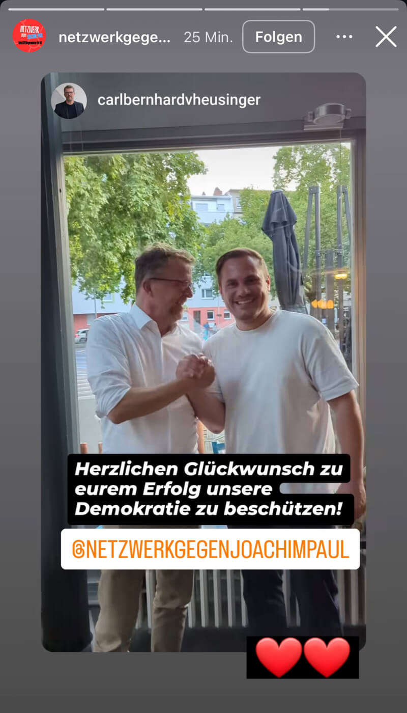 Der Grünen-Landtagsabgeordnete feiert mit einem Parteikollegen aus Ludwigshafen die Entscheidung des Wahlausschusses.